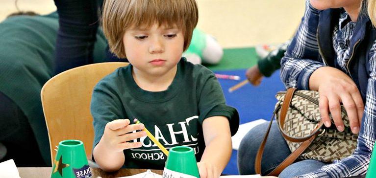 Chase Collegiate Pre-K student crafting with teacher